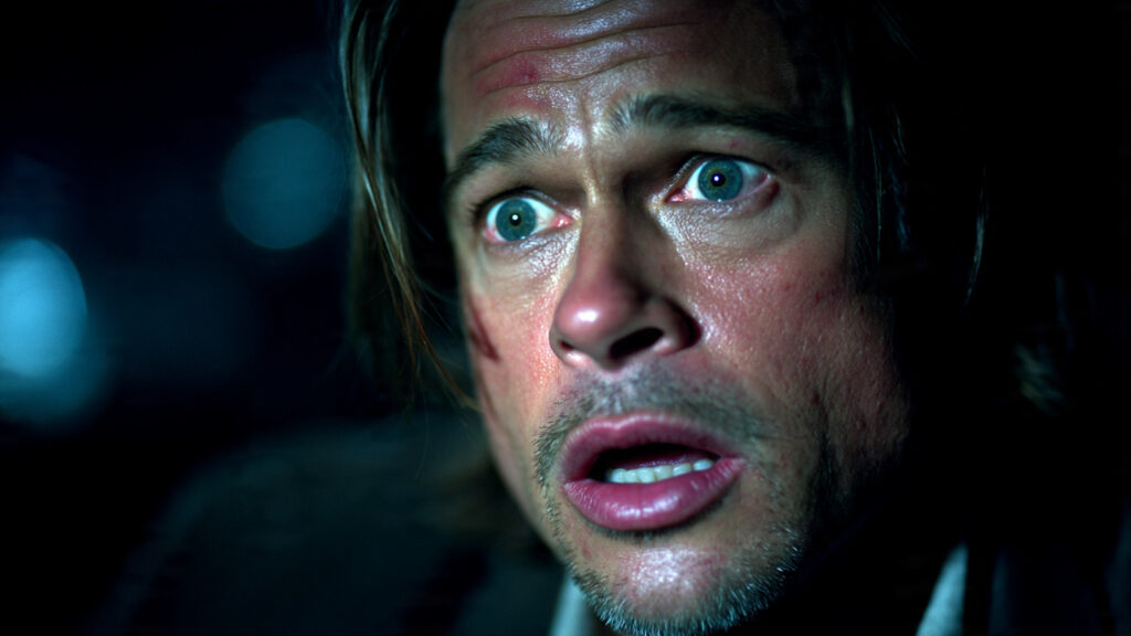 David Fincher's Dark Vision: Why His Thriller Seven Stands the Test of Time 3 A close-up shot of Brad Pitt's Detective Mills looking shocked and horrified, his face illuminated by a single, harsh light.