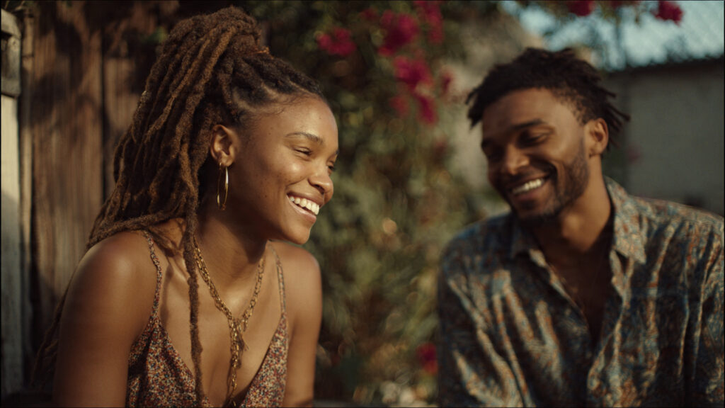 Halle Bailey and Regé-Jean Page Spark in Predictable Yet Utterly Charming Italian Rom-Com 4 Halle Bailey and Regé-Jean Page in a candid, joyful moment, perhaps laughing together.