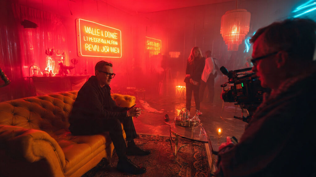 Nicolas Winding Refn directing a scene with striking neon lighting