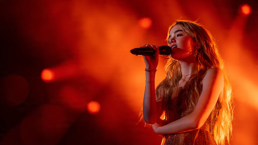Sabrina Carpenter's "Sabrinawood" Takes Over Coachella 2026: A Night of Vintage Glamour and Surprise Cameos 2 Sabrina Carpenter performing under dramatic lighting at Coachella 2026
