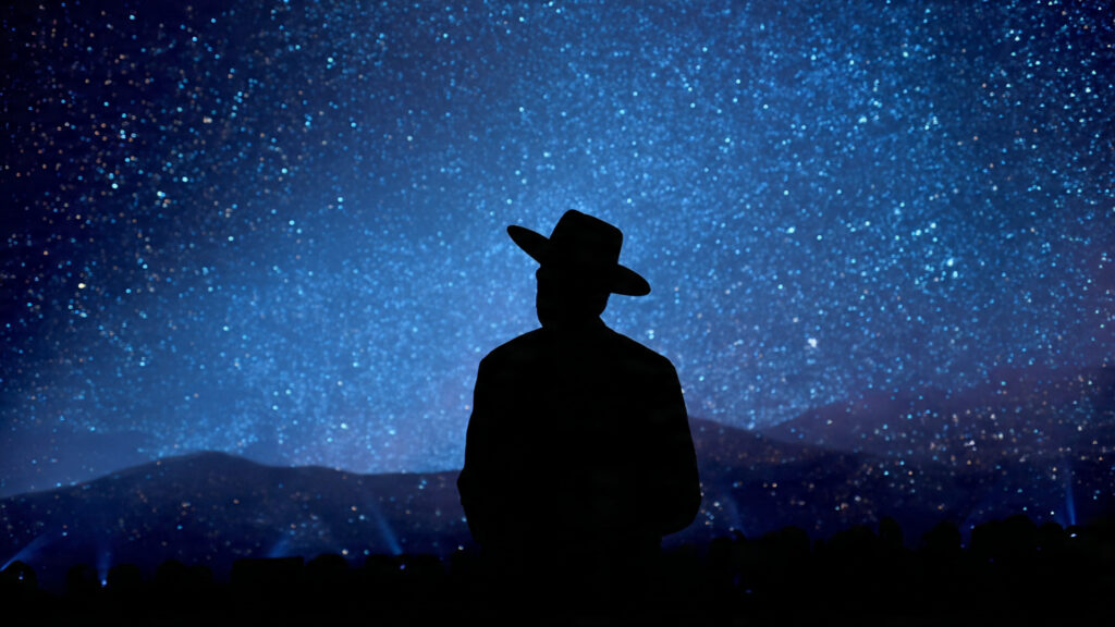 Sabrina Carpenter's "Sabrinawood" Takes Over Coachella 2026: A Night of Vintage Glamour and Surprise Cameos 3 Silhouette of Sam Elliott against a starry desert sky backdrop during Sabrina Carpenter's performance