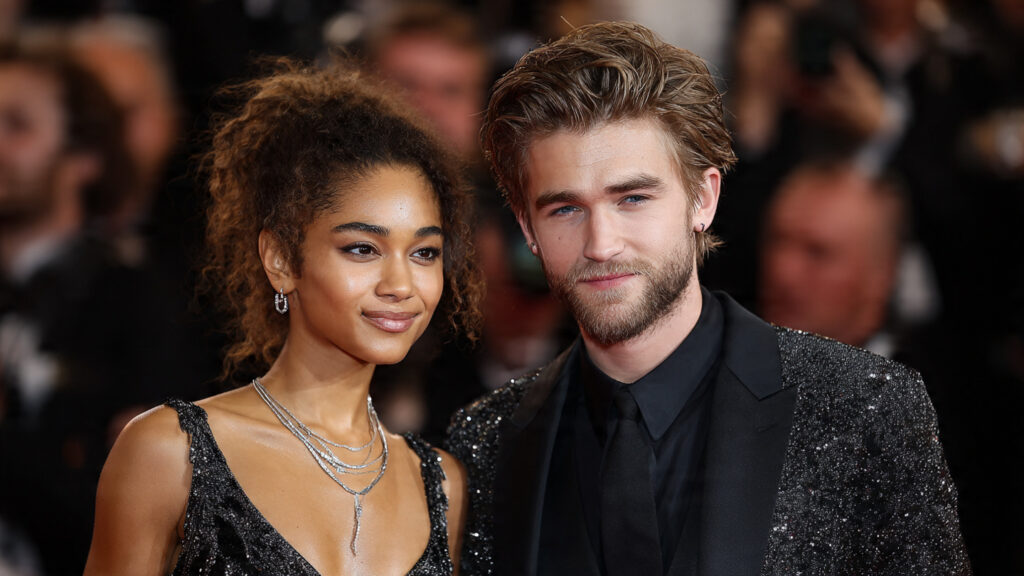 Zendaya and Robert Pattinson posing together on a red carpet